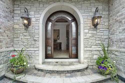 Arched stone entry to luxury home